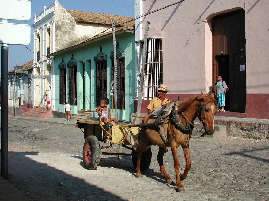Horse-drawn cart driven by man and boy in Trinidad street